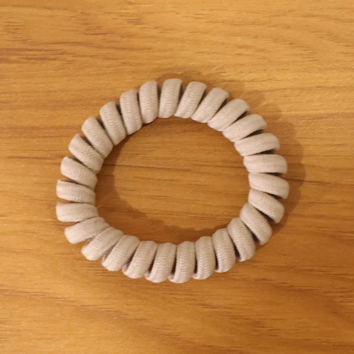 Multiple spiral coil hair bands in assorted shades, offering versatile styling.