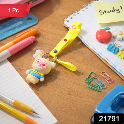 Close-up of teddy bear keychain showcasing cartoon design and vibrant yellow silicone loop strap