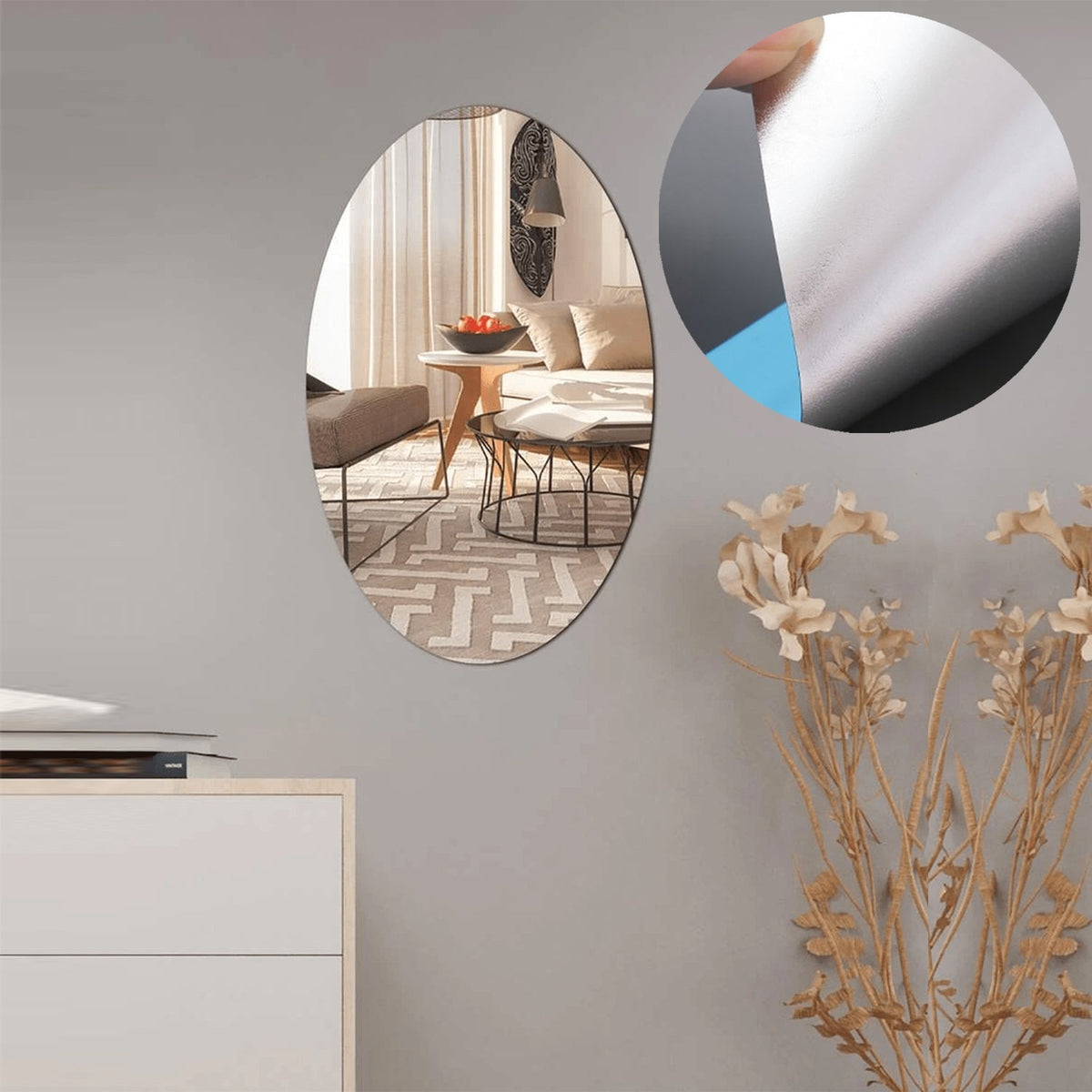 An oval mirror sticker applied to a textured wall, reflecting ambient light.