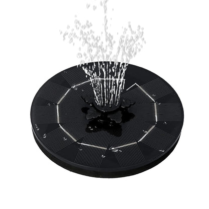 The solar floating water fountain demonstrating a wide, gentle spray pattern in a garden pool.