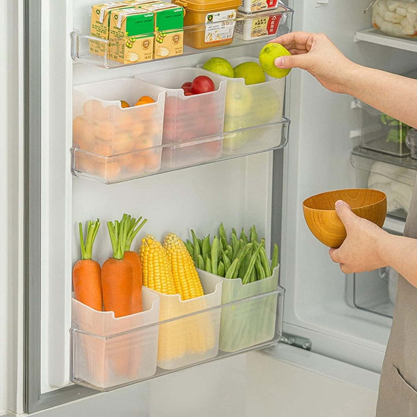 Top-down view of a clear plastic drawer organizer with several small items inside.