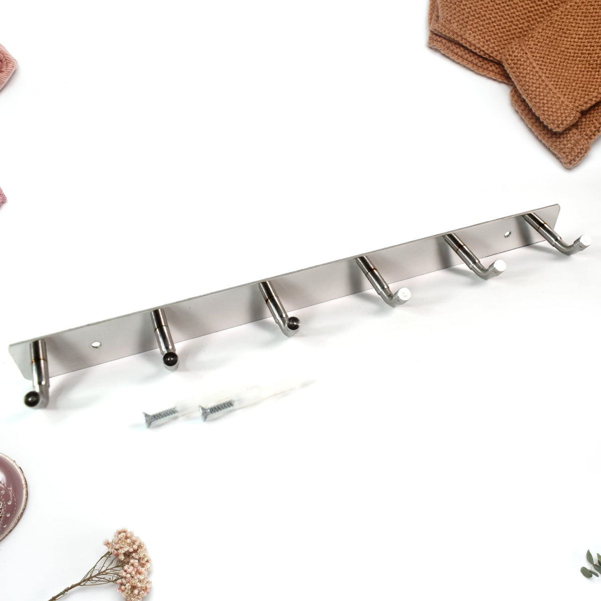 Close-up view of stainless steel hooks with smooth rounded edges on coat rack