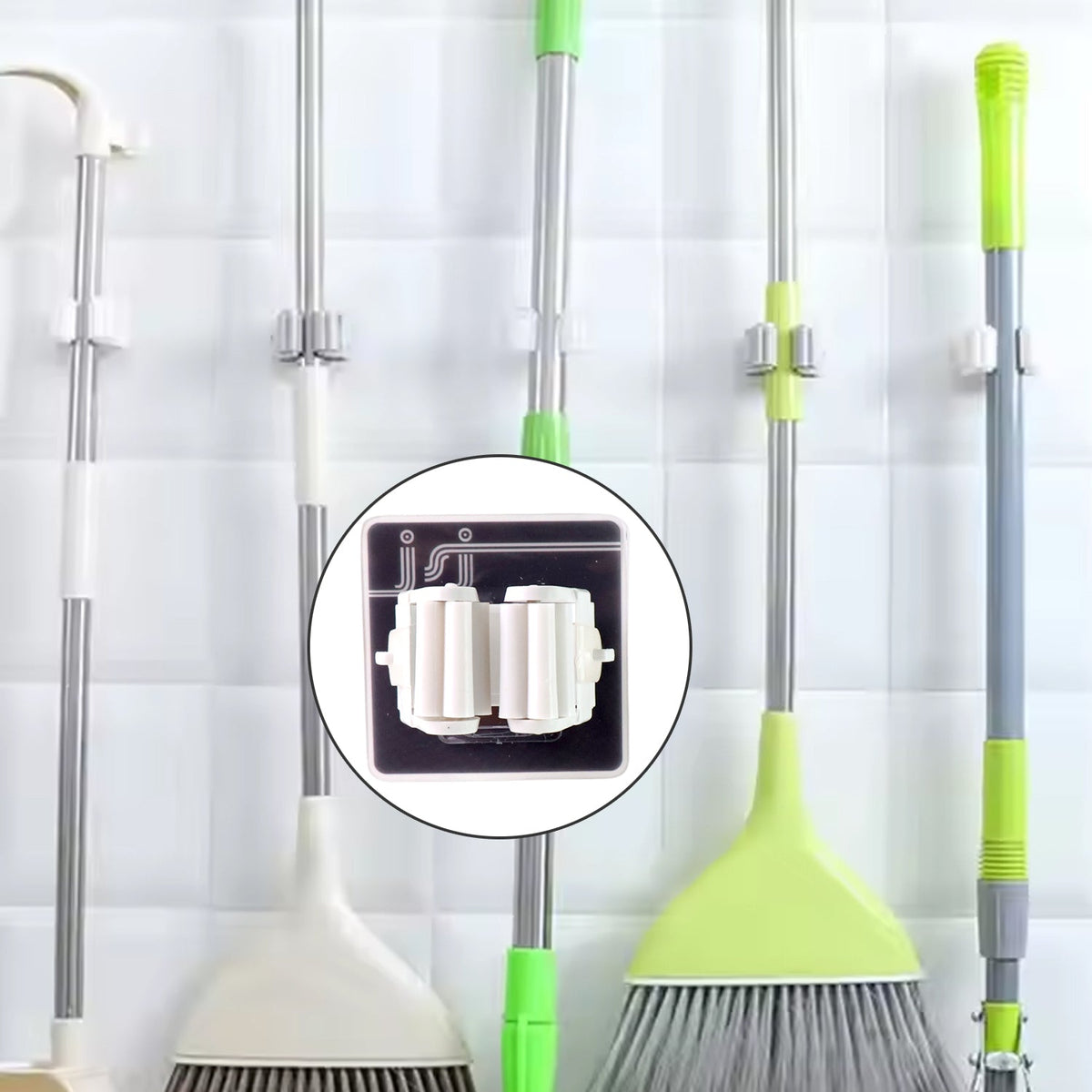 Single adhesive mop holder securely holding a mop on a wall.