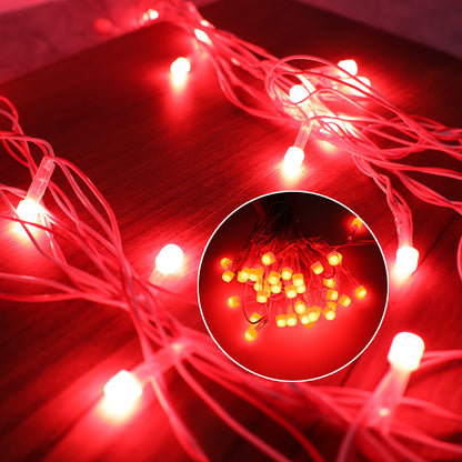 Red LED decorative string lights plugged in and emitting festive light