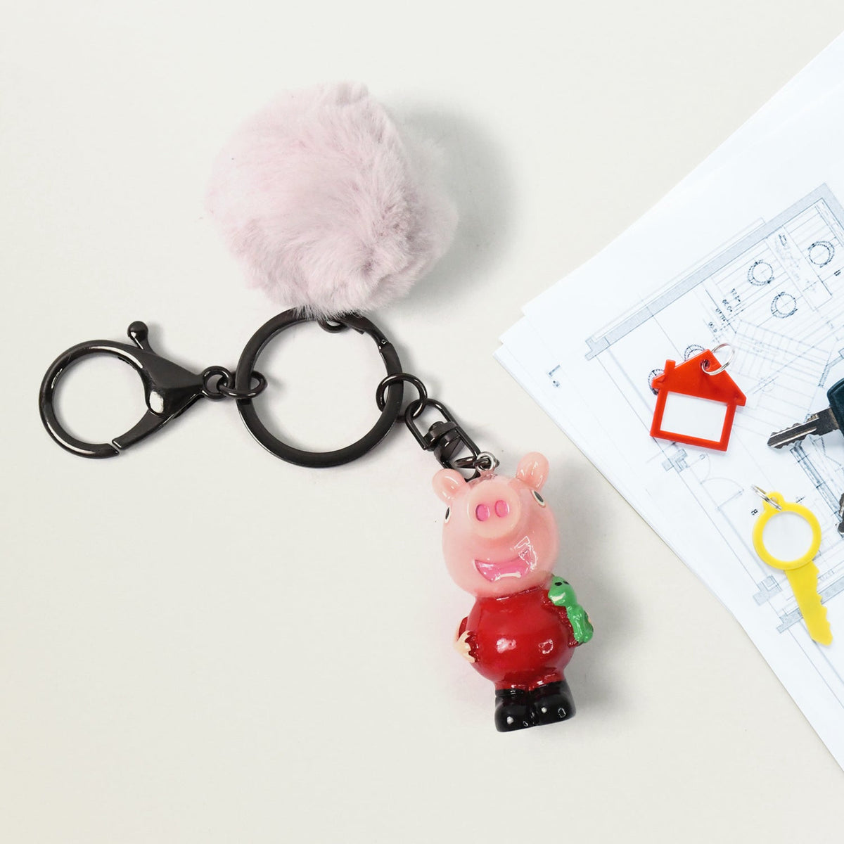 Colorful cartoon keychain with fluffy pom pom adding playful charm