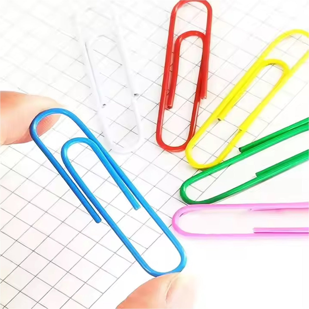 Hand holding documents securely clipped with assorted color U-shape paper clips