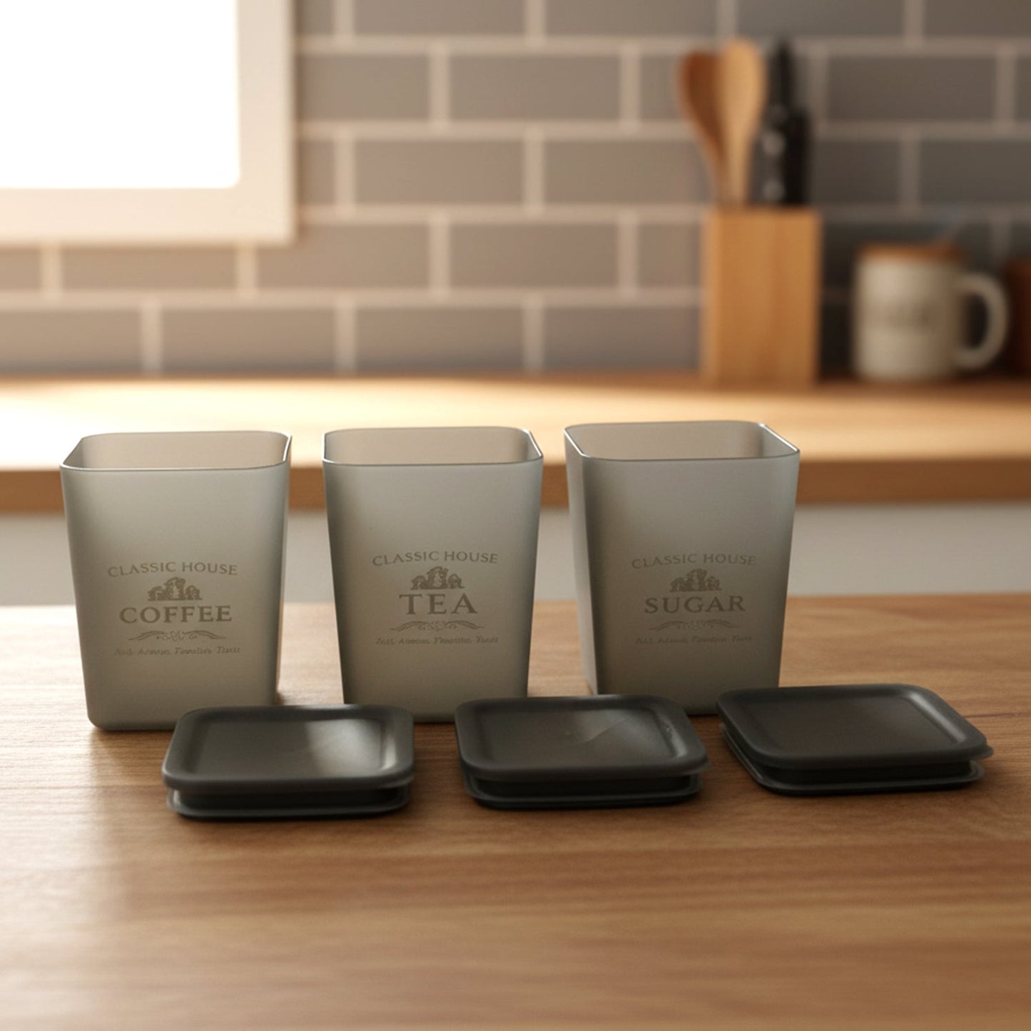 Neatly arranged kitchen storage jars for coffee, sugar, and tea storage
