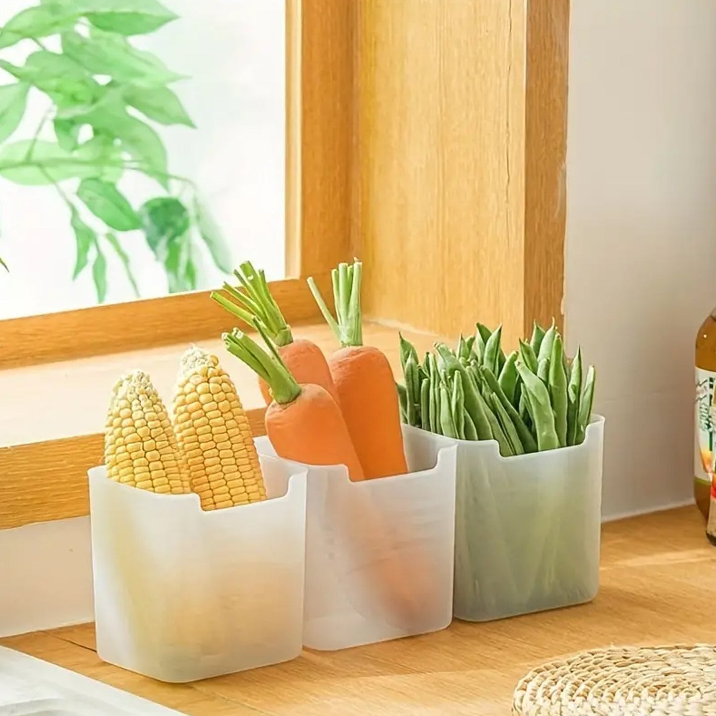 Versatile clear plastic drawer organizers tidying up a kitchen drawer with utensils.
