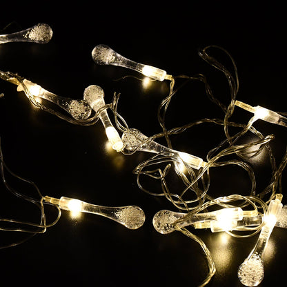 Decorative LED string lights draped over a curtain in a living room.