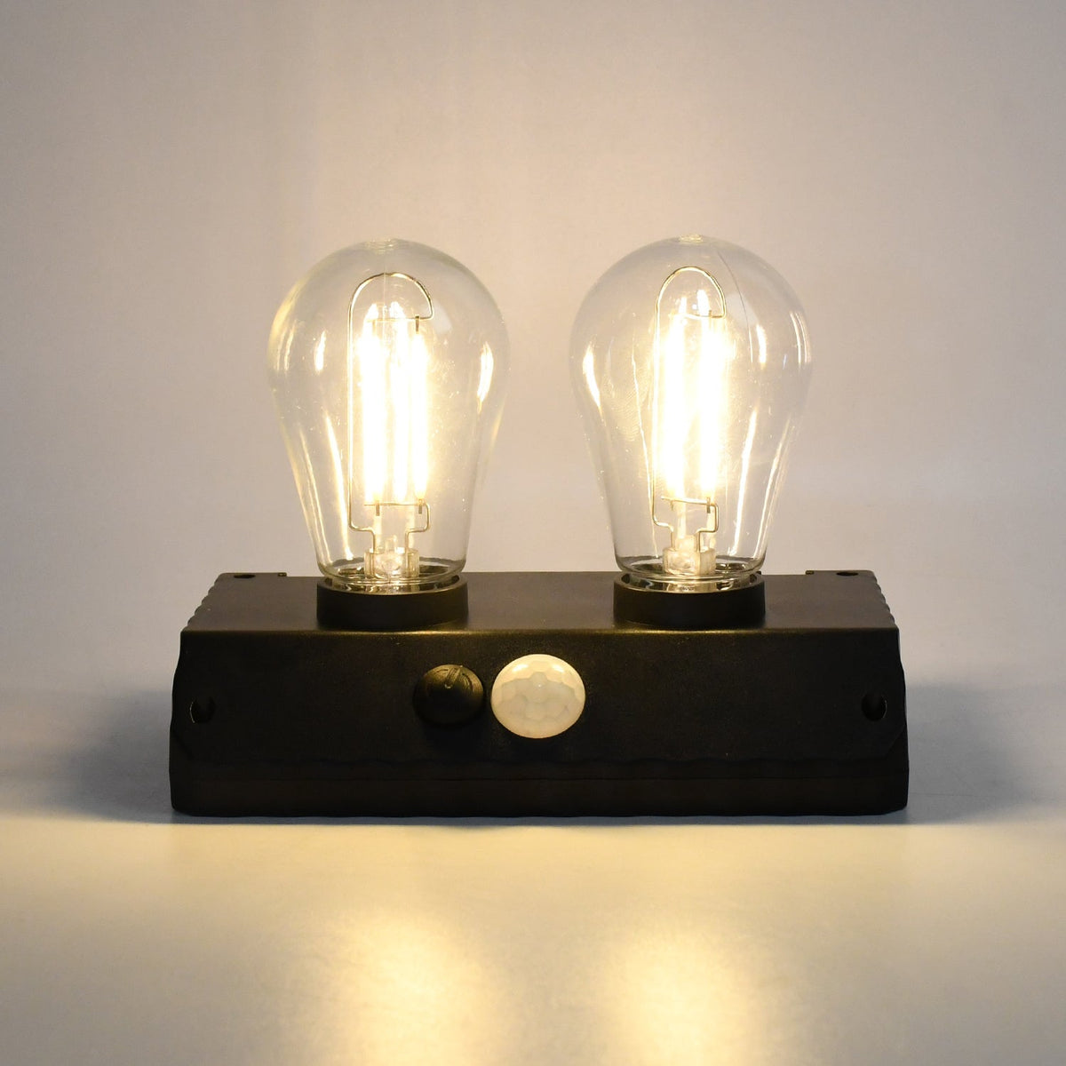 Indo Glow Solar Double LED Lamp providing ample light for an outdoor area.