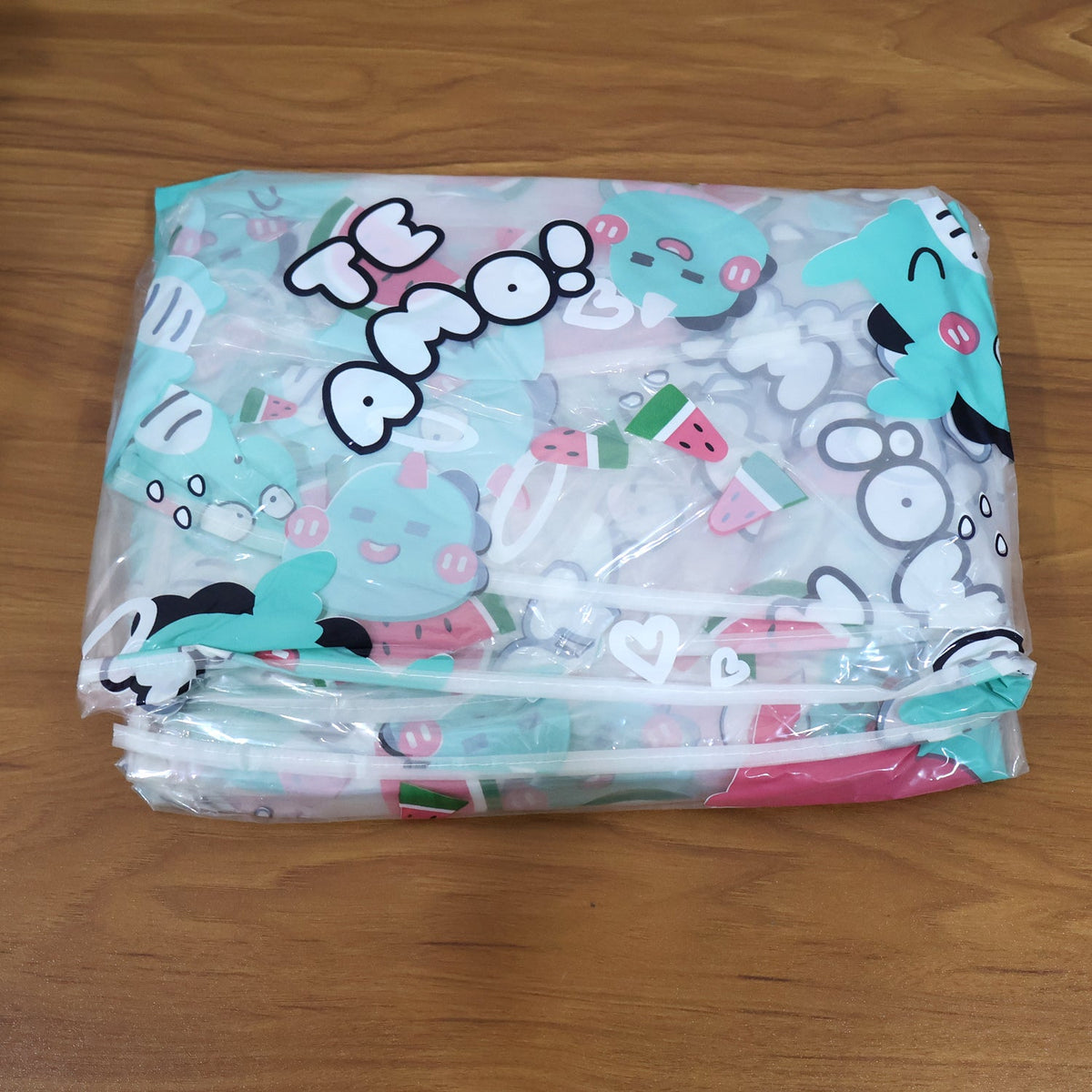 Close-up of waterproof PE plastic film on bicycle rain cover with cute graphic print