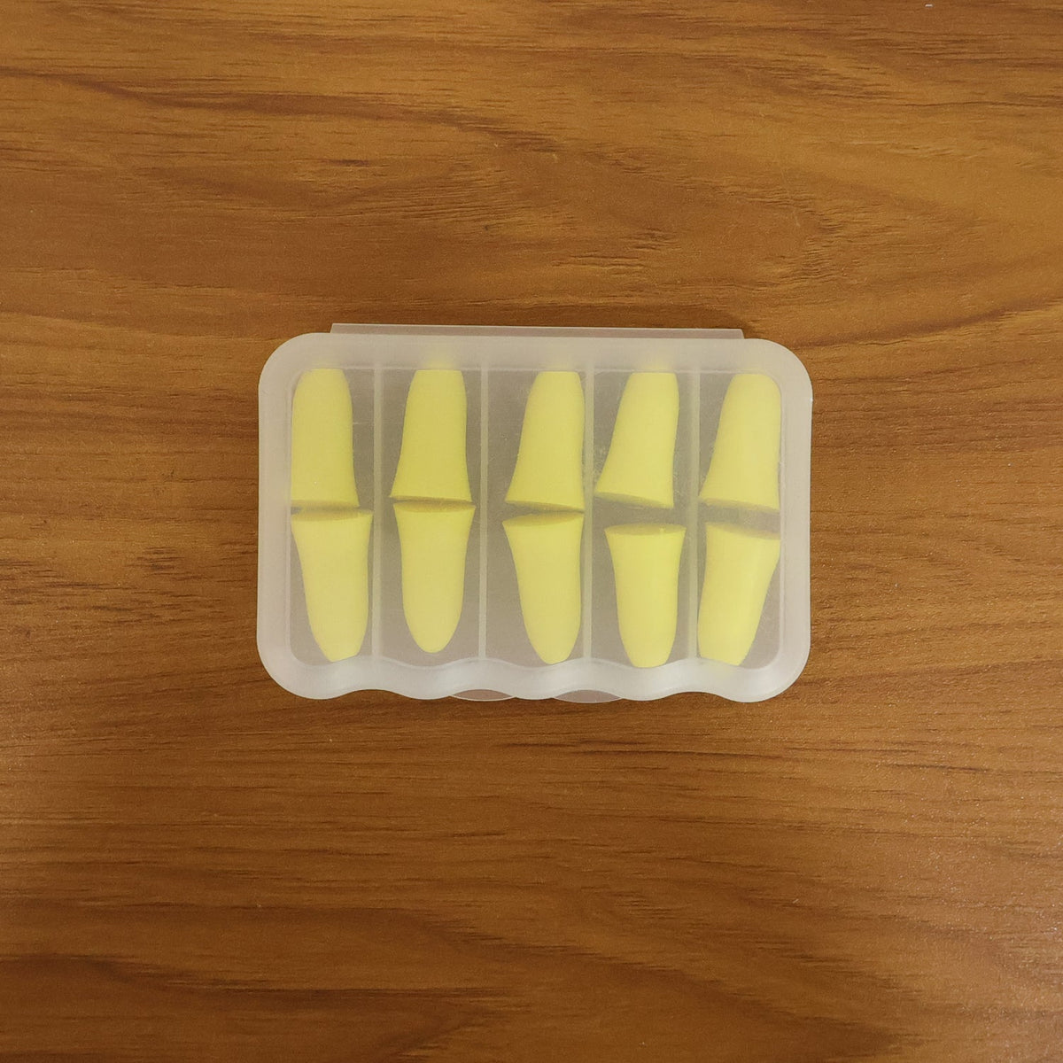 Soft foam ear plugs packed in portable plastic storage case