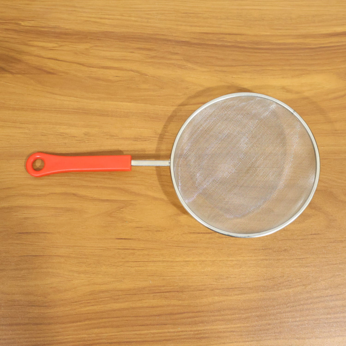 Close-up of fine mesh kitchen strainer's strong grip handle