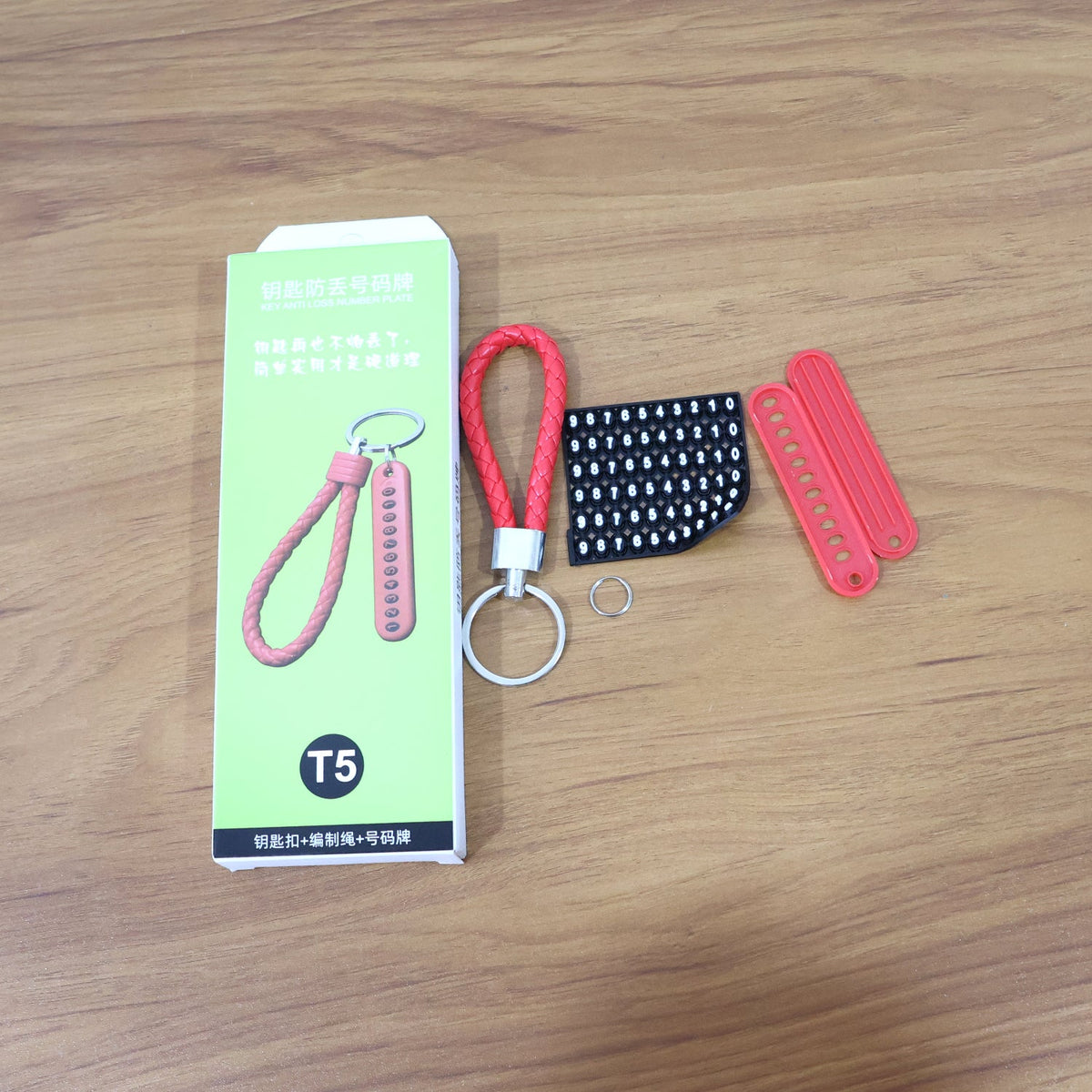 Keychain featuring vibrant red braided strap and unique numbered plate for identification