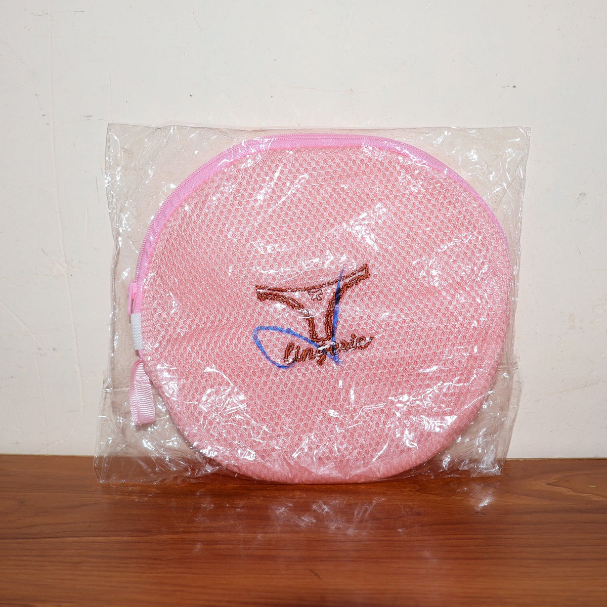 Various delicate garments neatly placed within the mesh laundry bag.