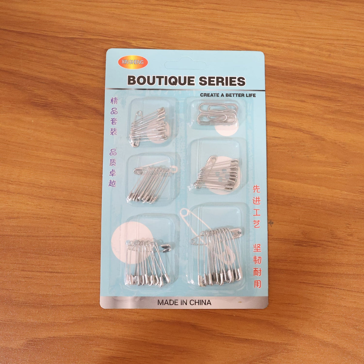 Organized set of rust-resistant metal safety pins in various sizes