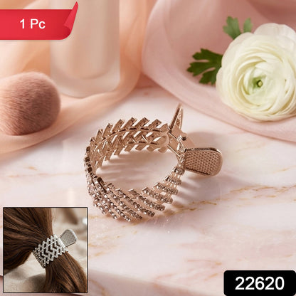 Close-up of stylish metallic hair claw clip with crystal embellishments