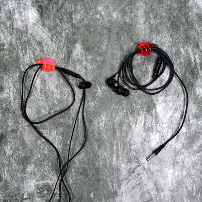 A set of multi-functional hand shape wall clips holding various items like cables and keys.