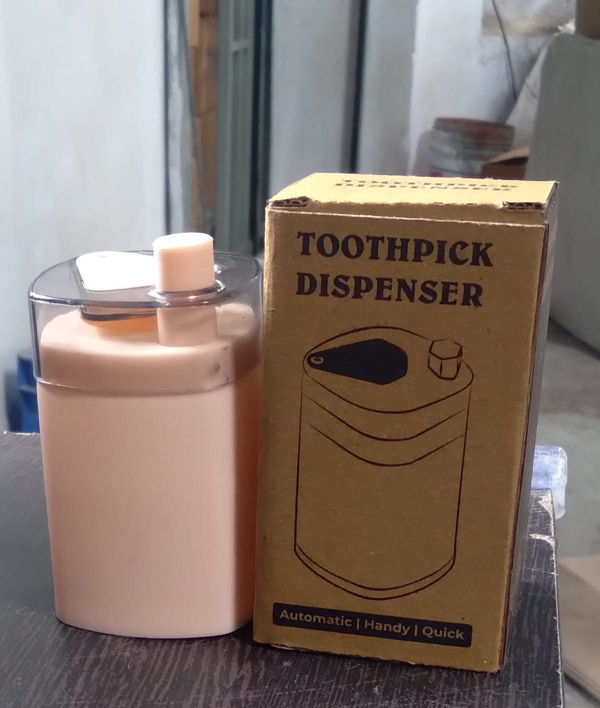 Automatic toothpick dispenser in a minimalist setting, ready for use.