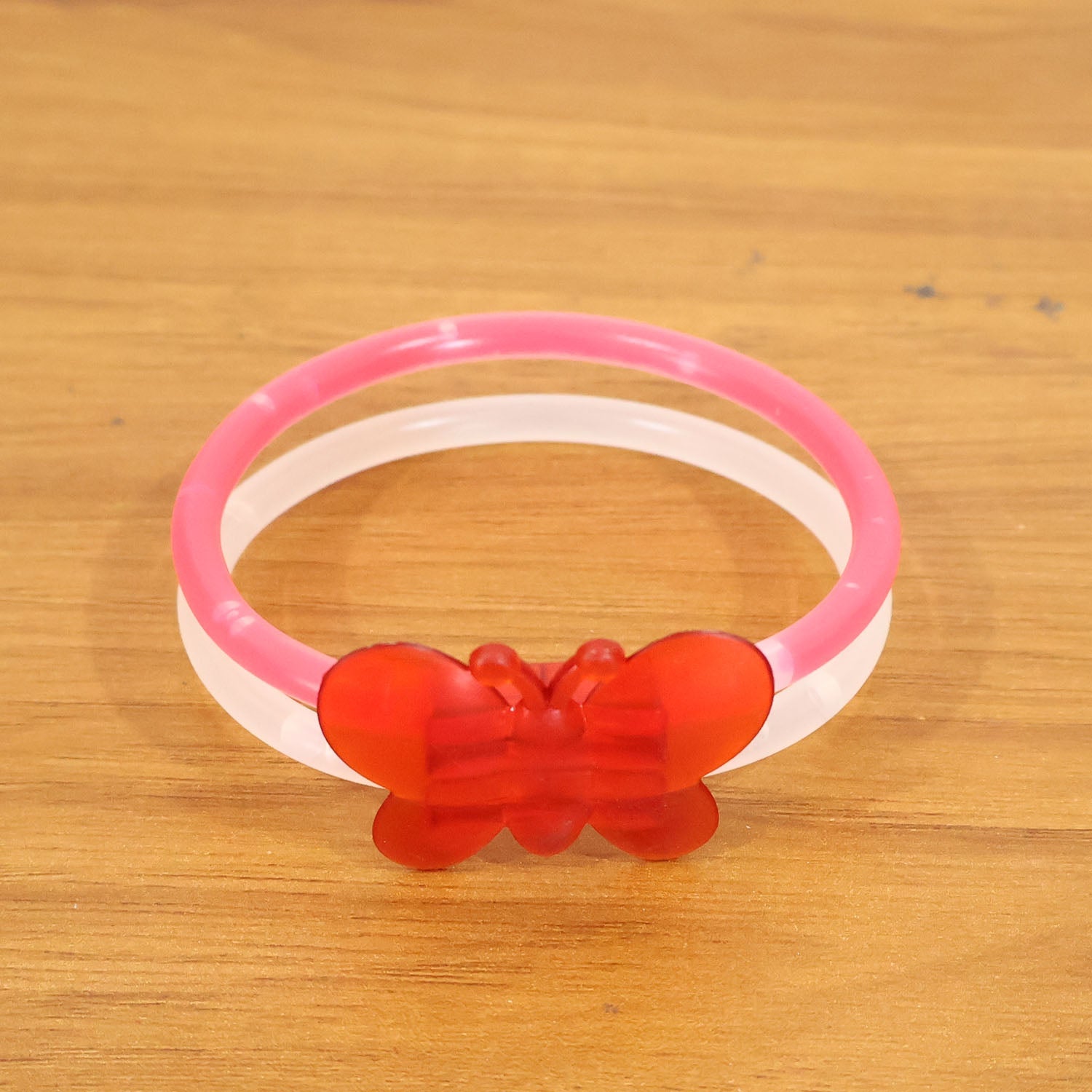 Glowing butterfly bracelet worn on wrist during night party