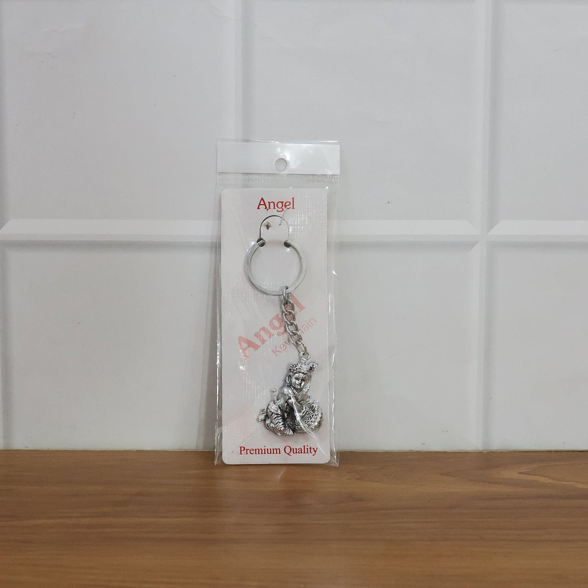 Bal Krishna Makhan Chor keychain attached to vehicle keys adding a spiritual charm