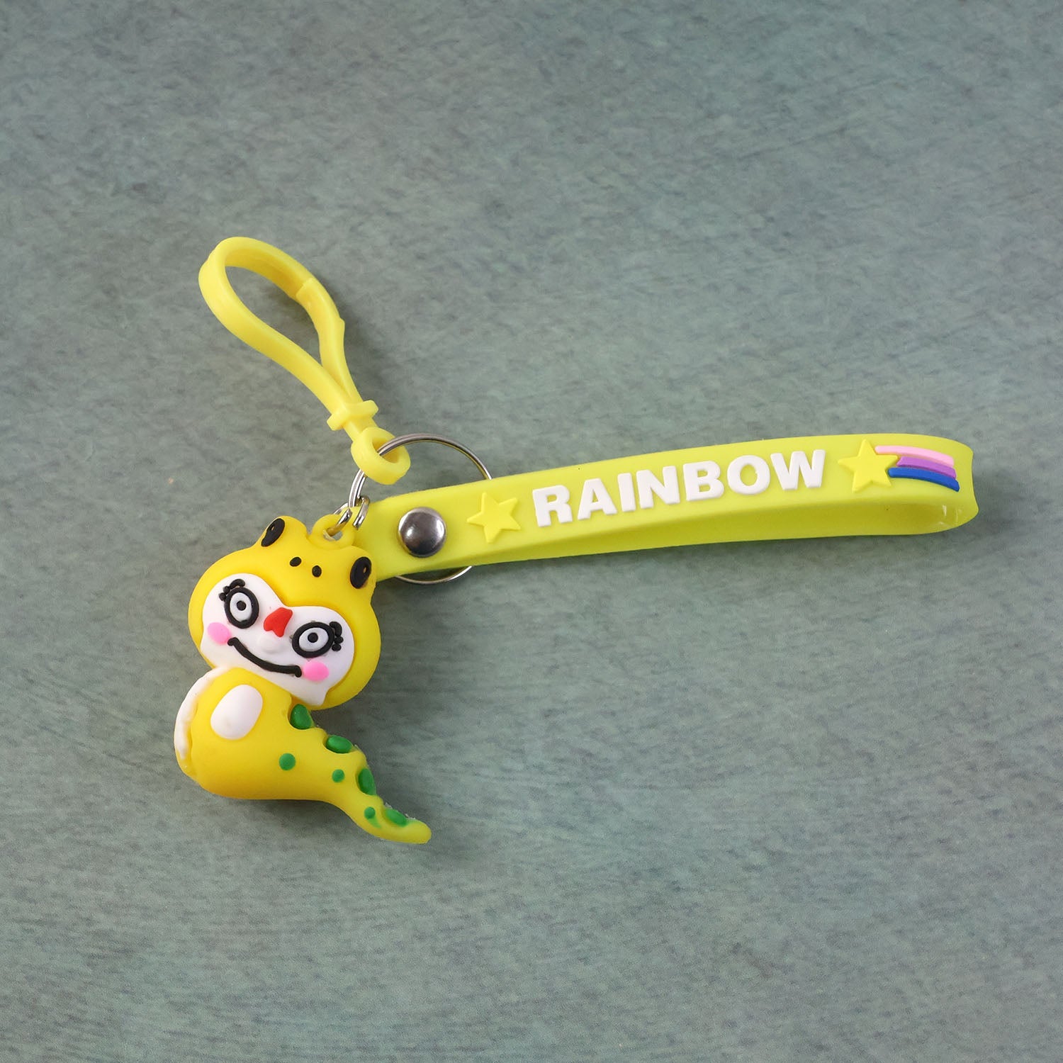 Keychain with cartoon dinosaur figure secured by metal clip hook