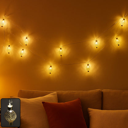 Flexible warm LED string light with decorative hollow metal balls