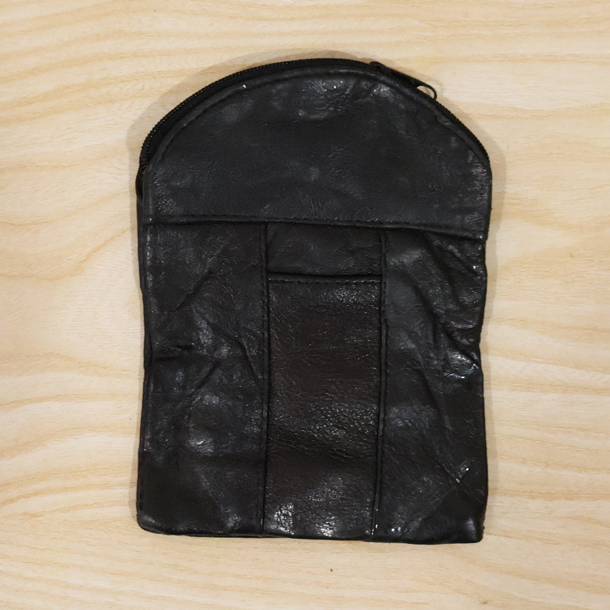 Laying down the black leather mini pouch with its slim profile. Swipeable.