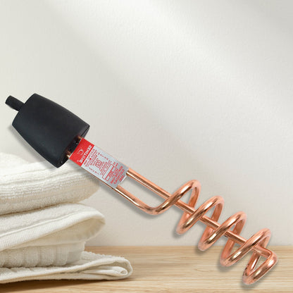 Close-up of copper heating element and insulated handle of water heater rod