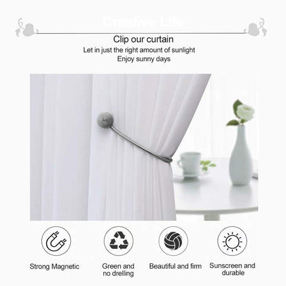 Magnetic curtain holdback with its two magnetic balls snapped together.