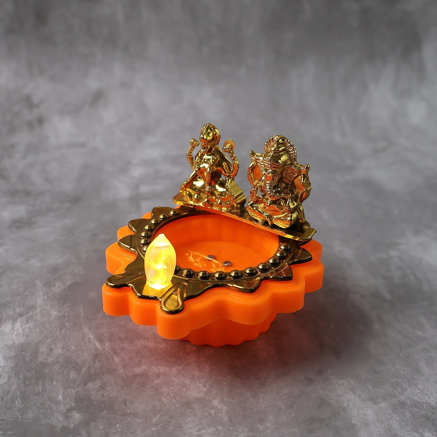 Water Sensor LED Diya with golden Laxmi Ganesh idols illuminating gently