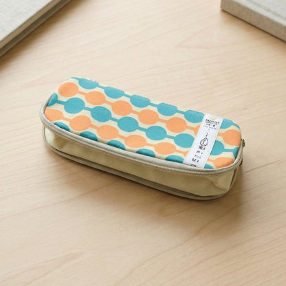 Multiple stationery items stored inside geometric printed pencil pouch
